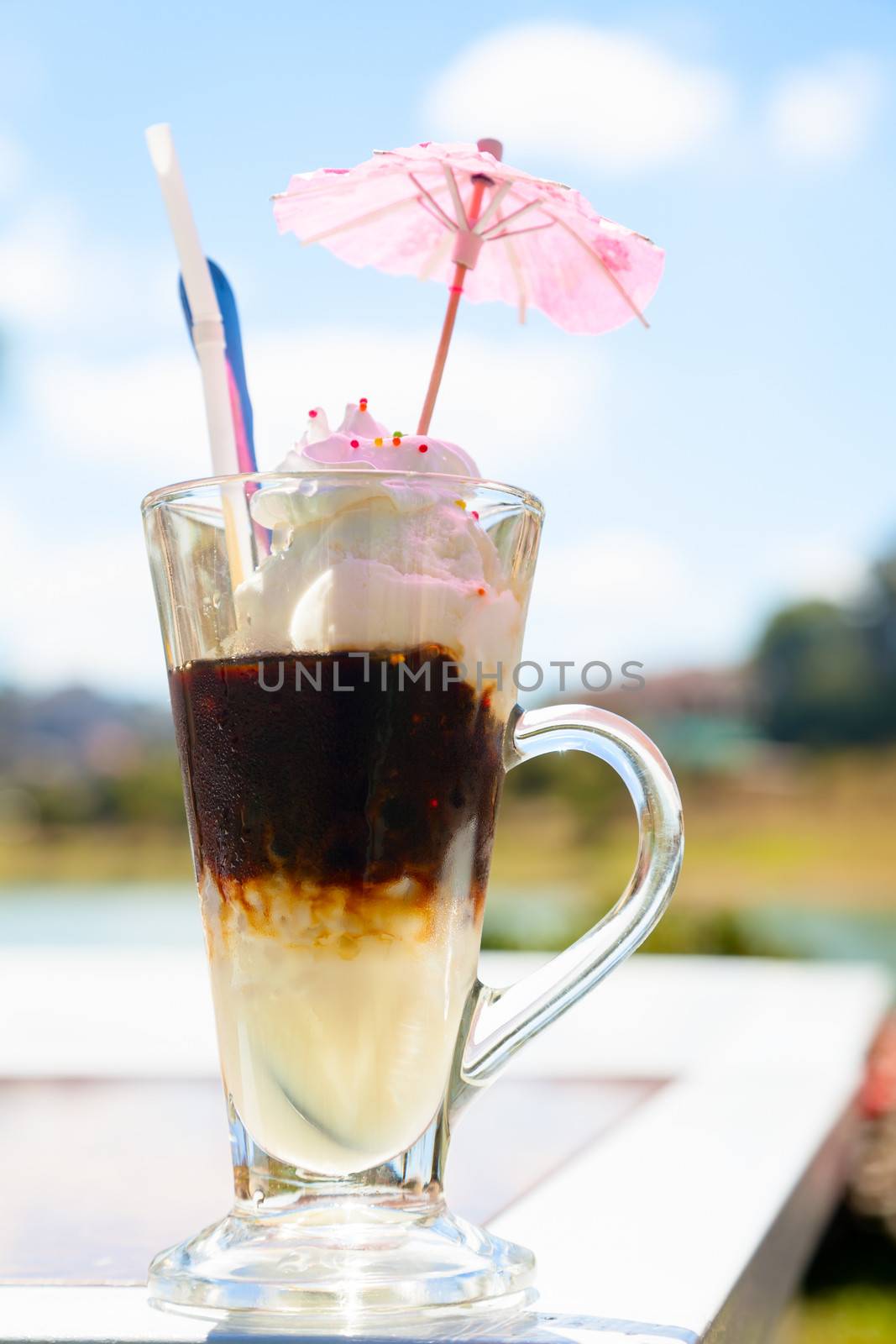 Iced coffee with ice-cream outdoors