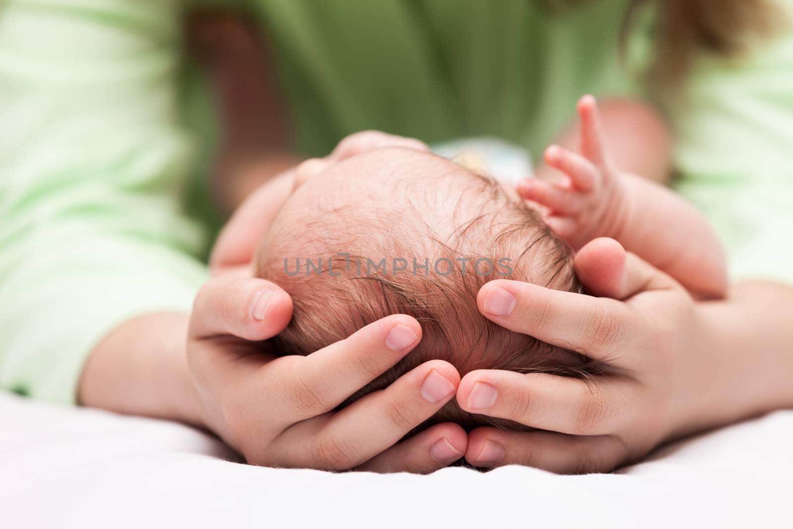 Cute sleeping newborn baby child on mother hands by ia_64