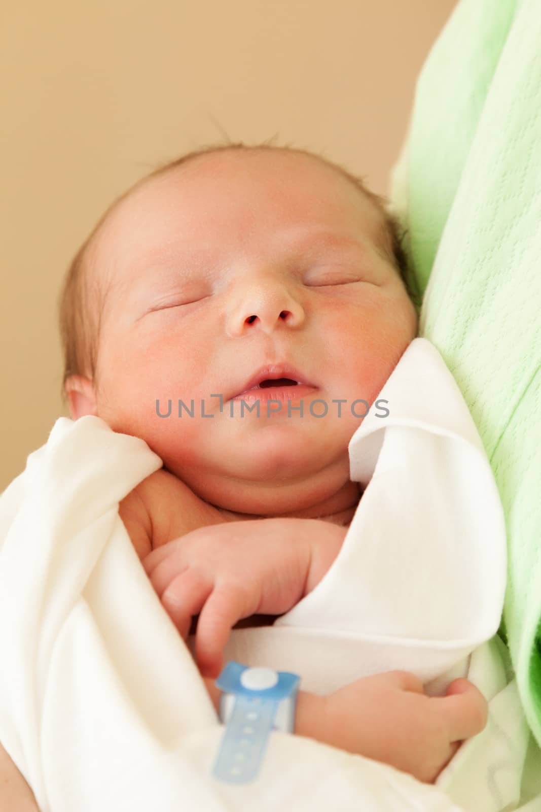 Cute sleeping newborn baby child on mother hands by ia_64