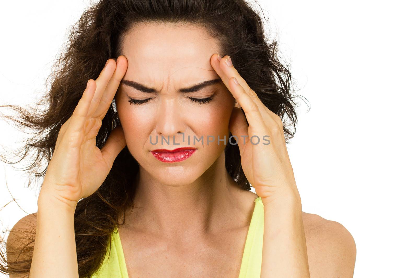 Close-up of a woman with a bad headache or migraine. Isolated on white.