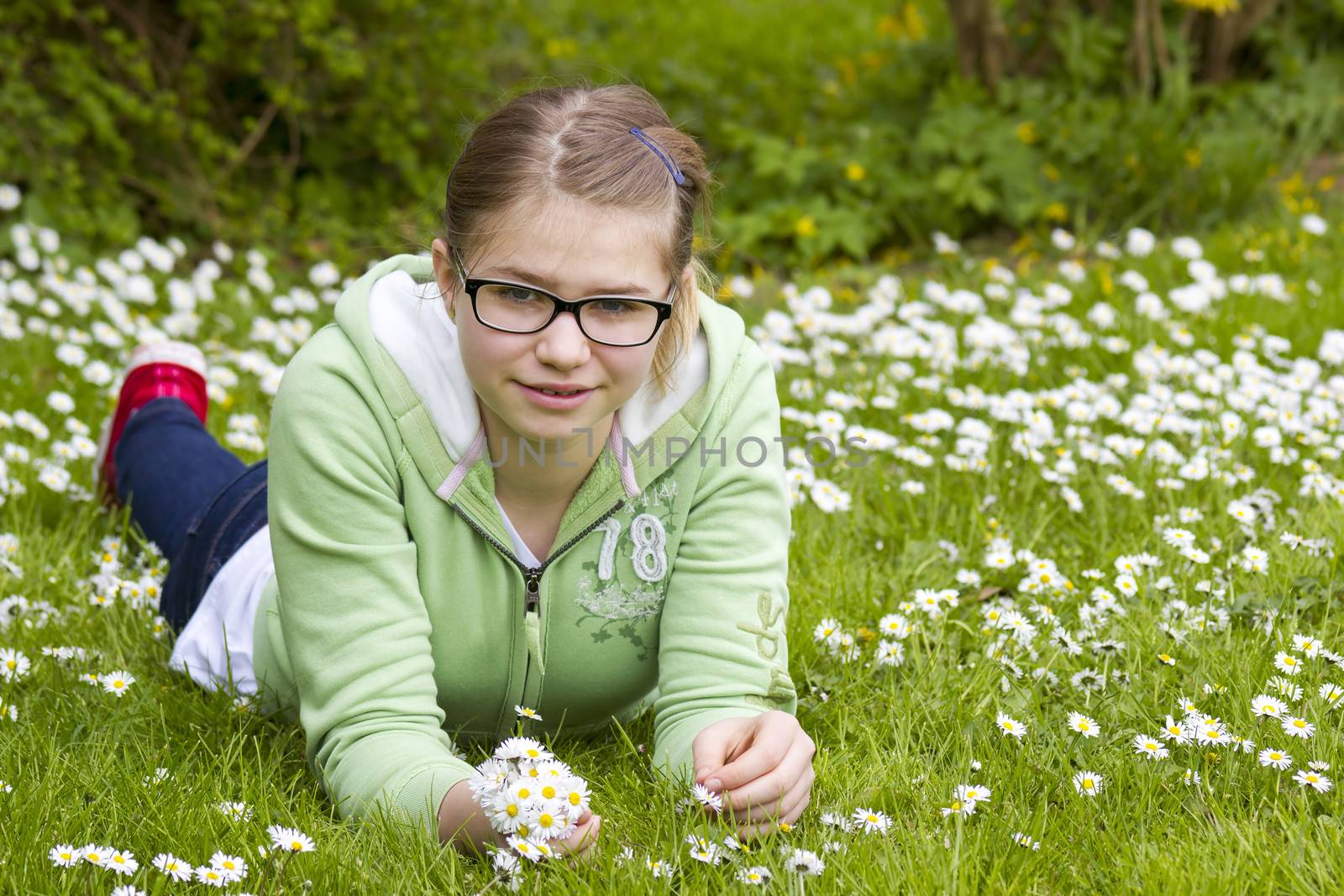 young girl picking daisies by miradrozdowski