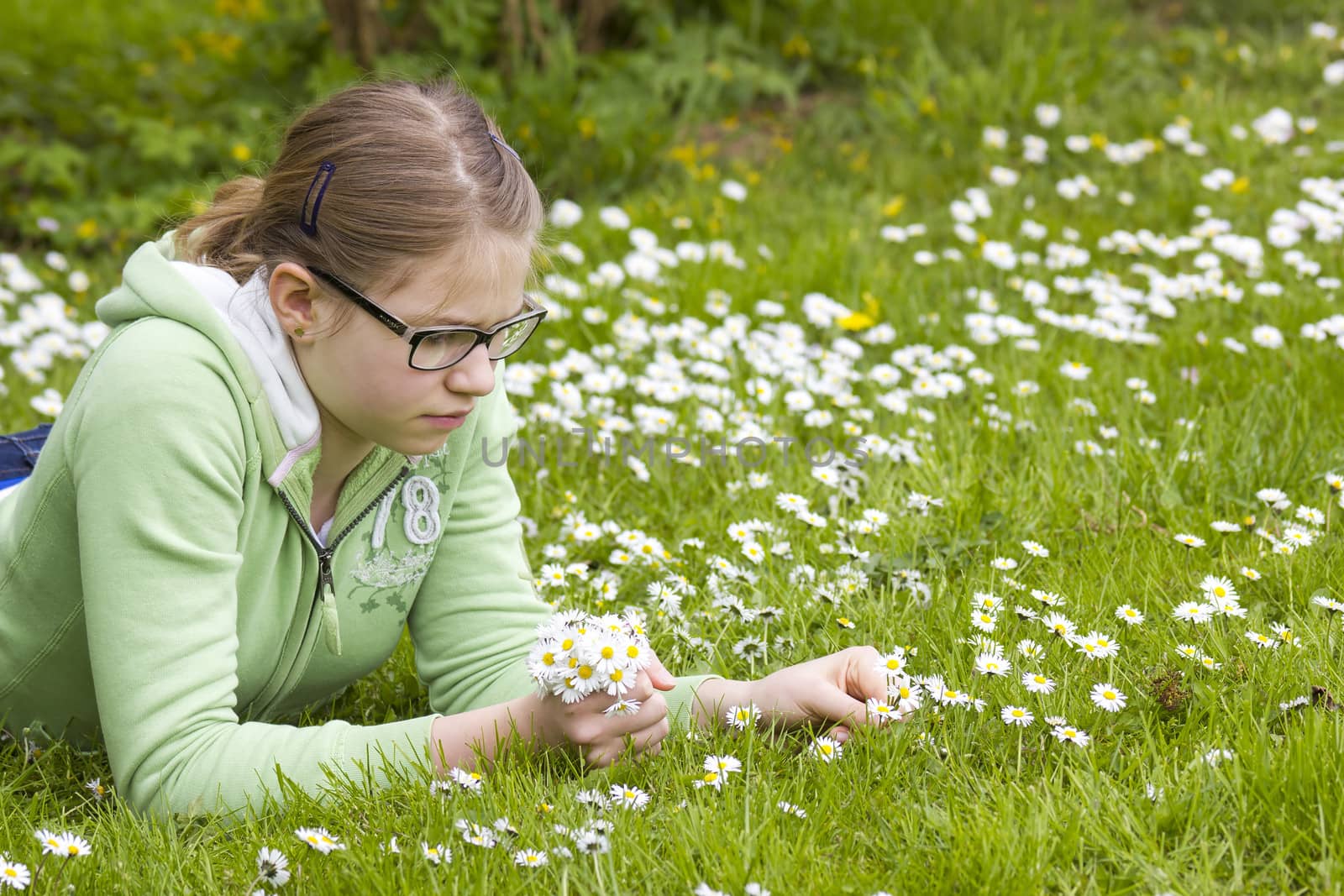 young girl picking daisies by miradrozdowski