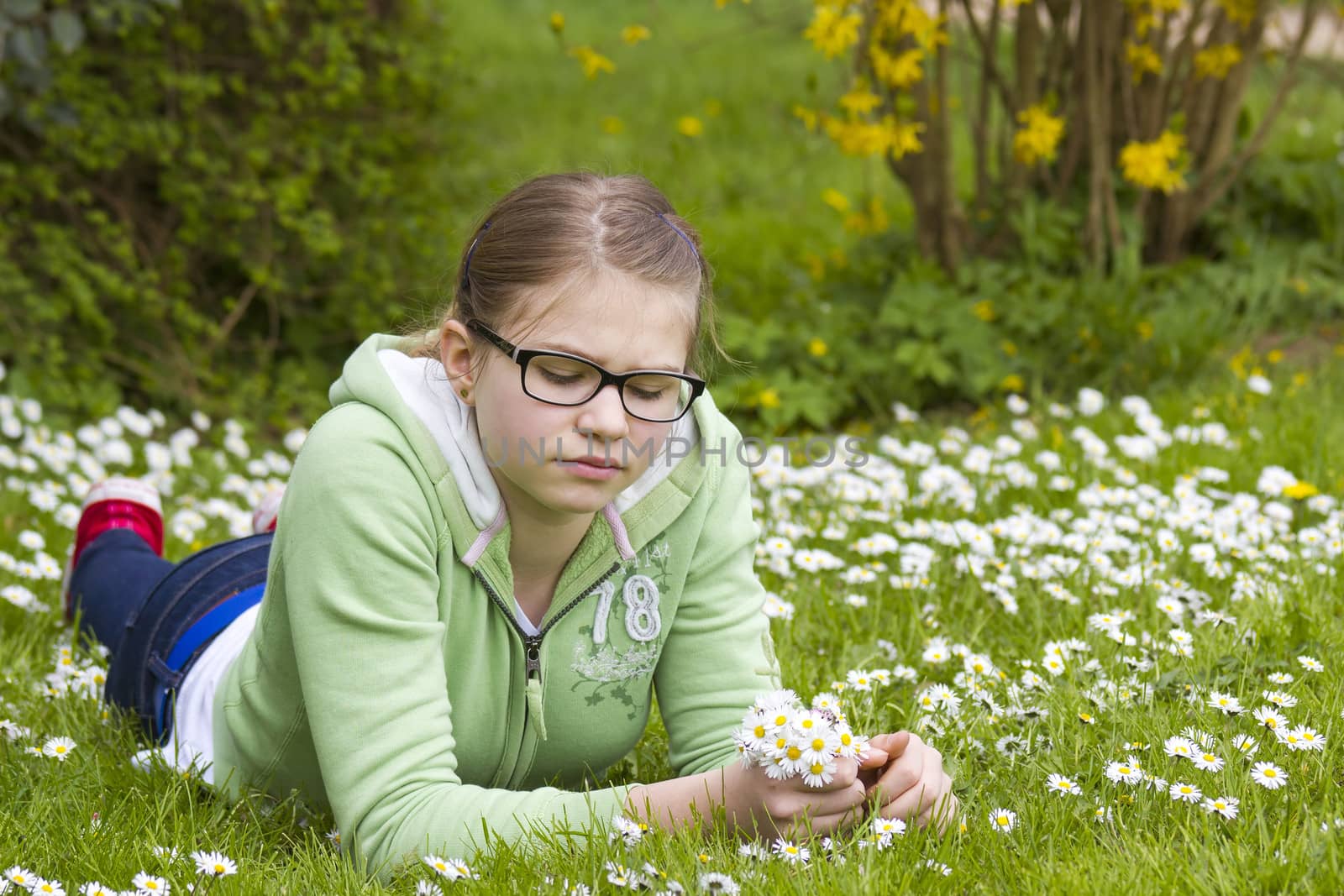 young girl picking daisies