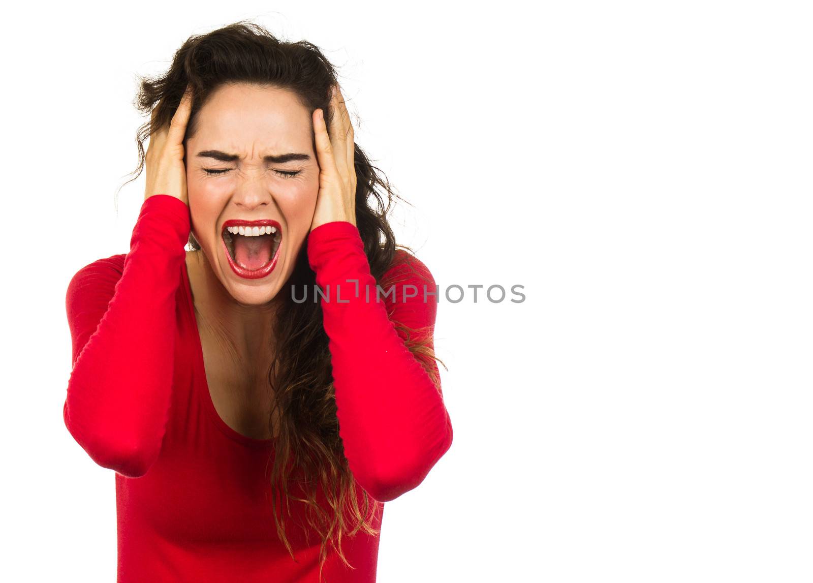 A very angry and frustrated woman screaming and covering her ears. Isolated on white.