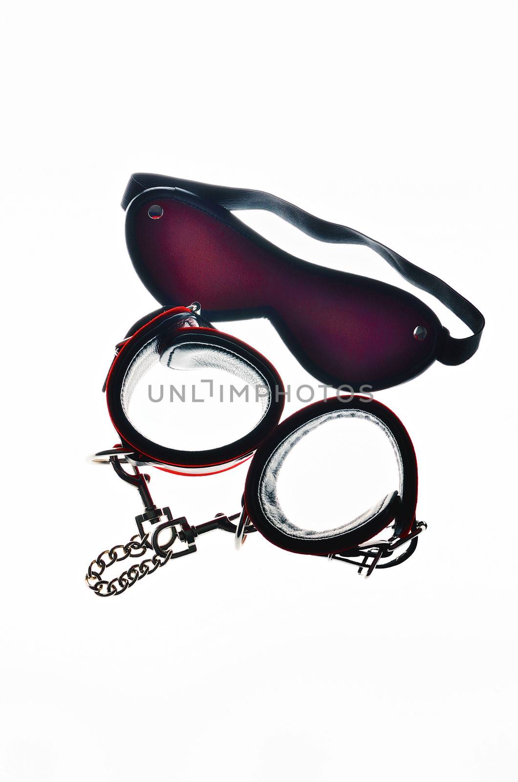 Red leather handcuffs and bandage for eyes