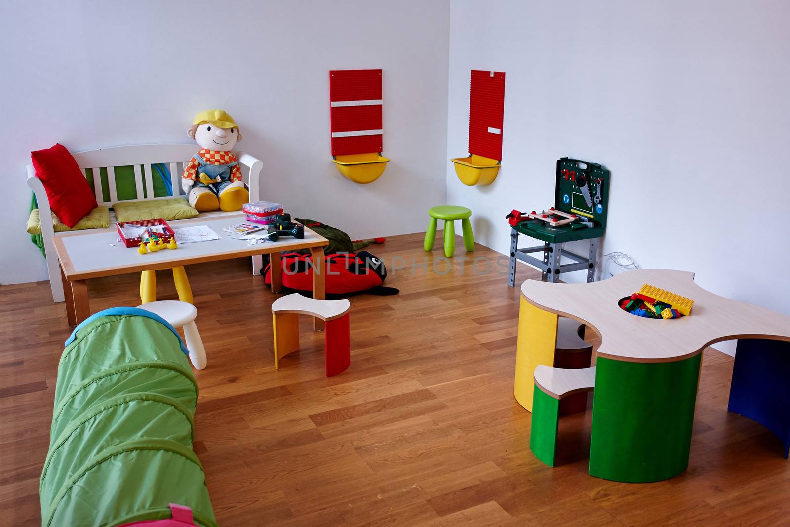 Colorful modern play children's room with variety of toys                               