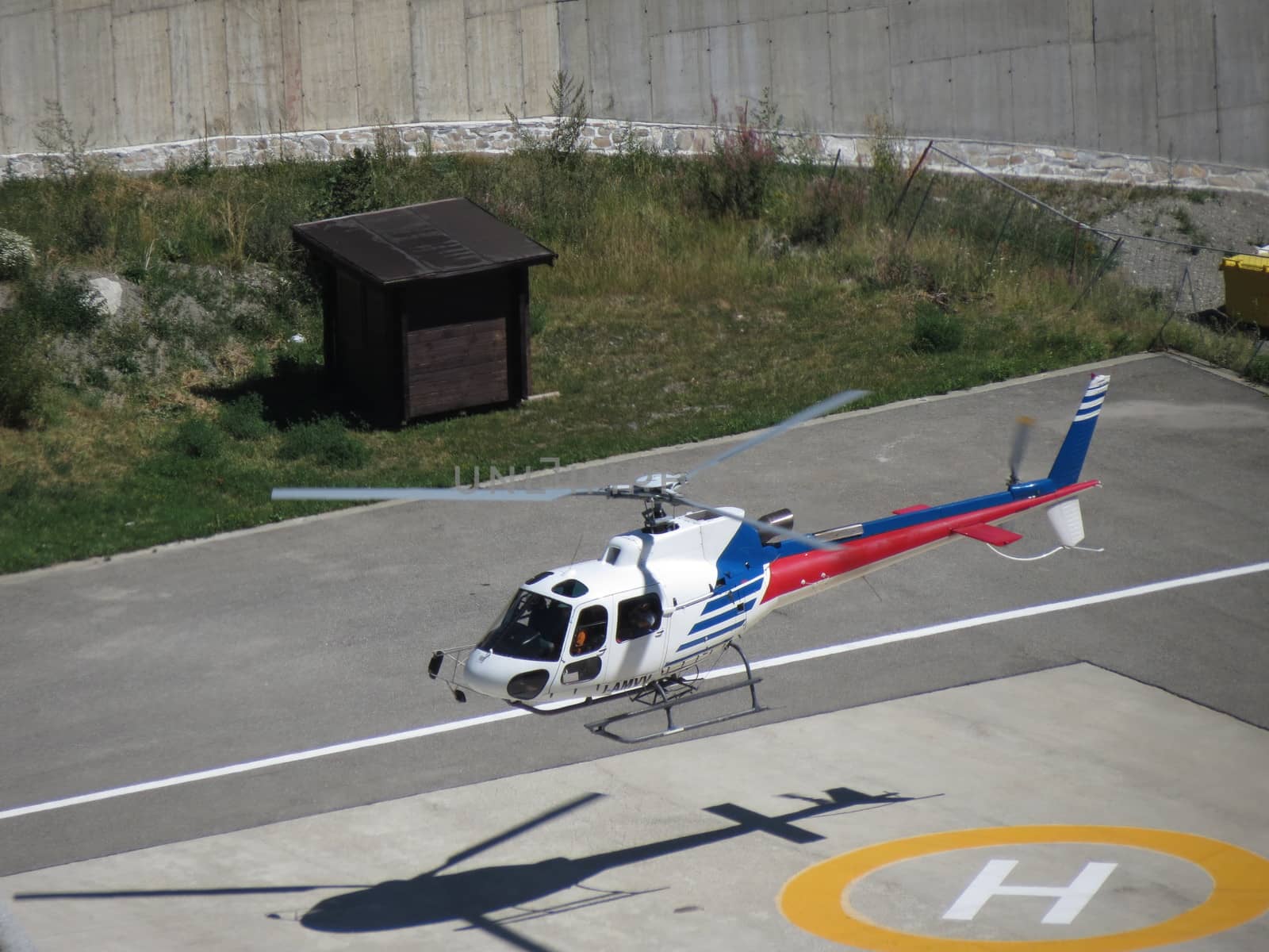 AOSTA, CIRCA AUGUST 2012 - Helicopter taking off in Aosta, August 2012