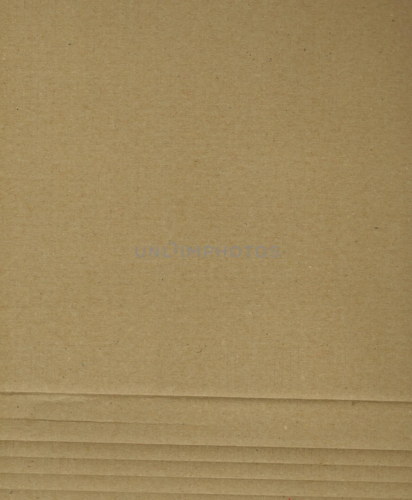 Brown corrugated cardboard sheet useful as a background