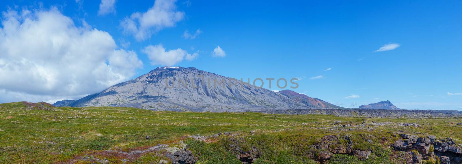 Iceland mountain cloudscape beautiful elongated clouds over Icelandic hills a sunny blue sky summers day picturing the ring road scenic tourism paradise travel landscape