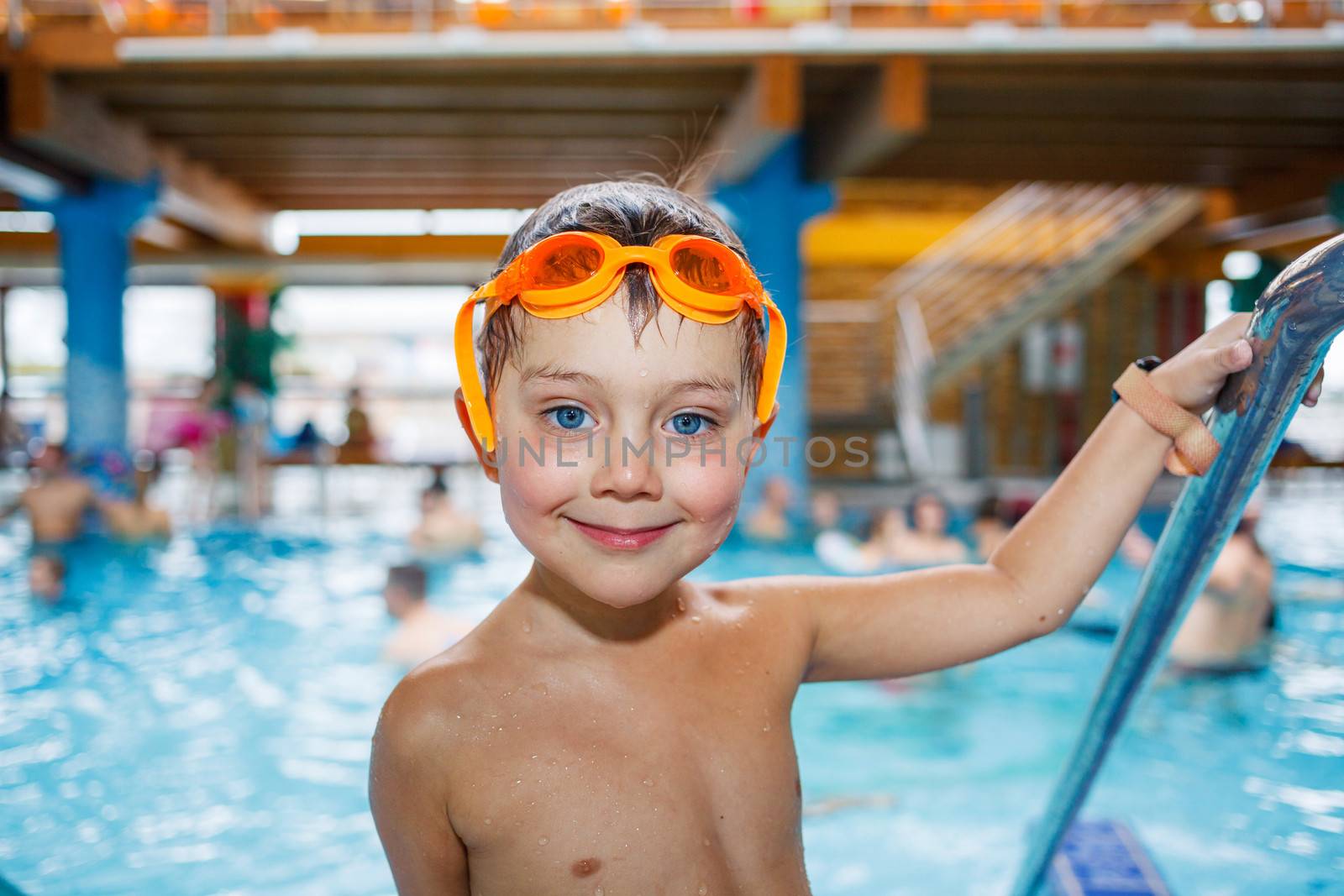 Activities on the pool. Cute boy in swimming pool