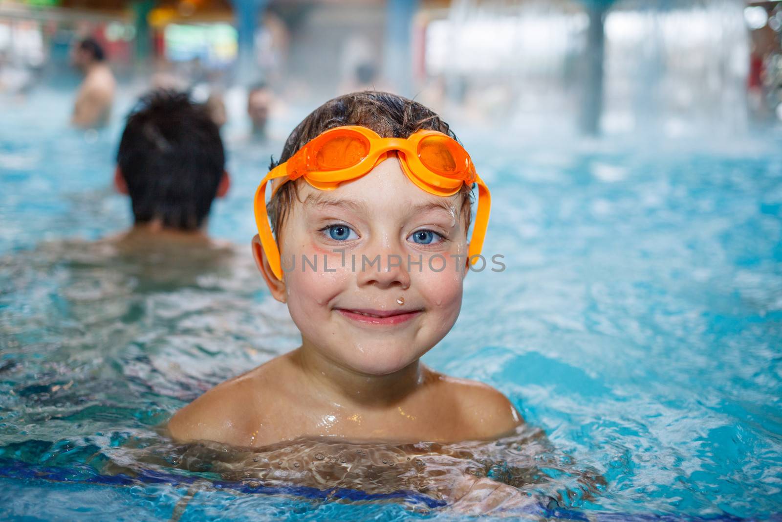 Activities on the pool. Cute boy in swimming pool