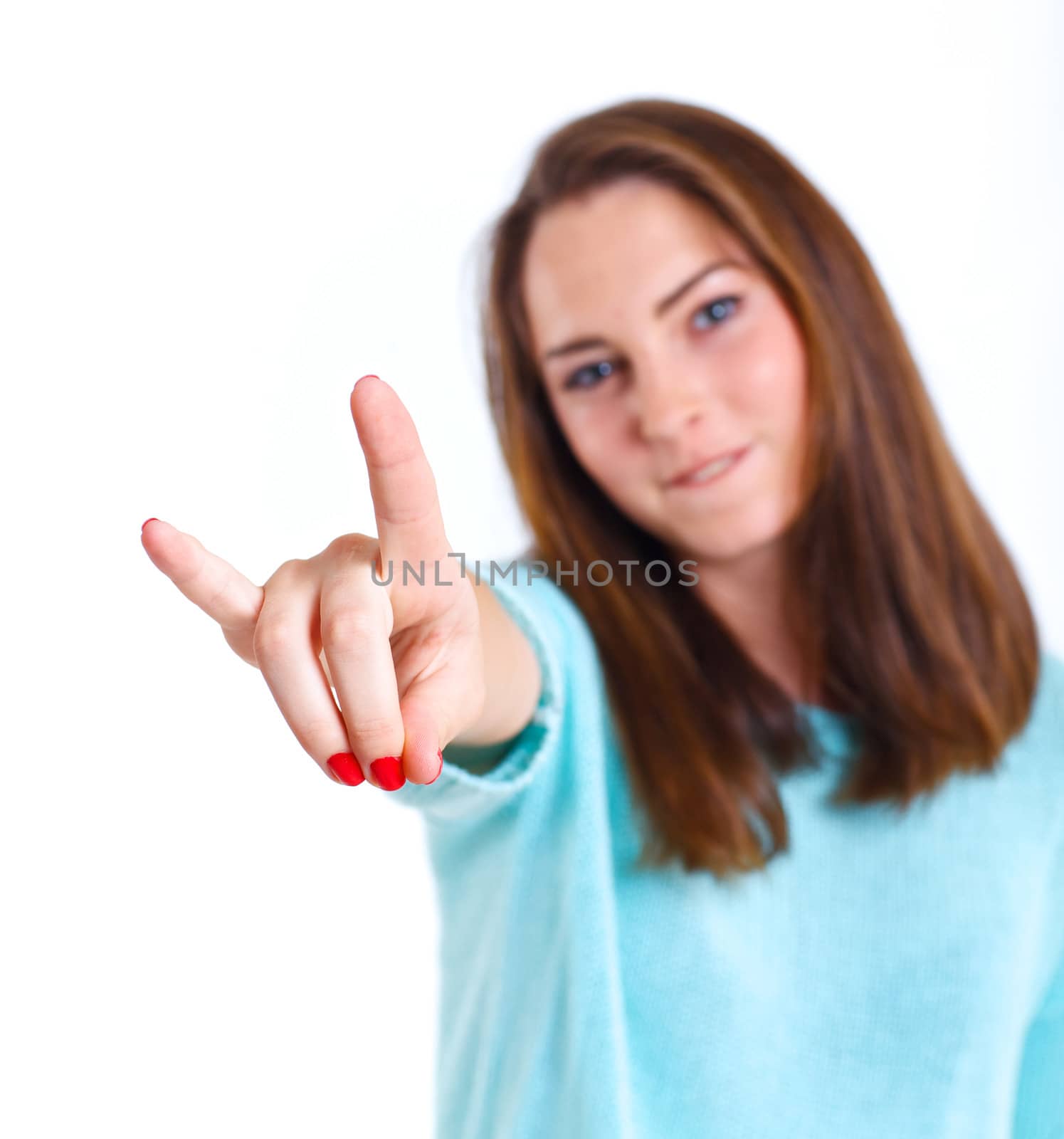 Portrait of happy teenage girl in a blue dress. Isolated over white background. Focus on the fingers
