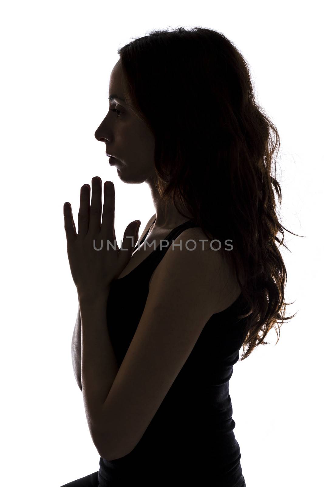 Meditating young woman, silhouette by snowwhite