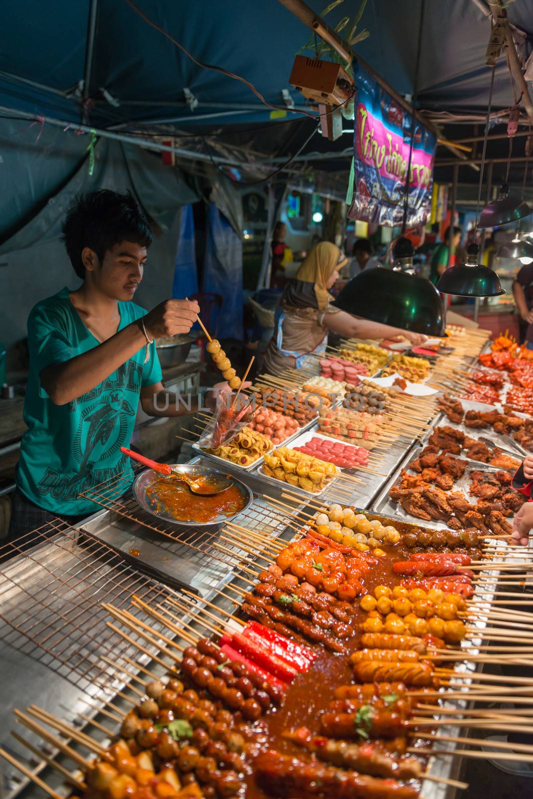 PHUKET, THAILAND - 07 FEB 2014: Unidentified man sell food on street during annual old Phuket town festival. 