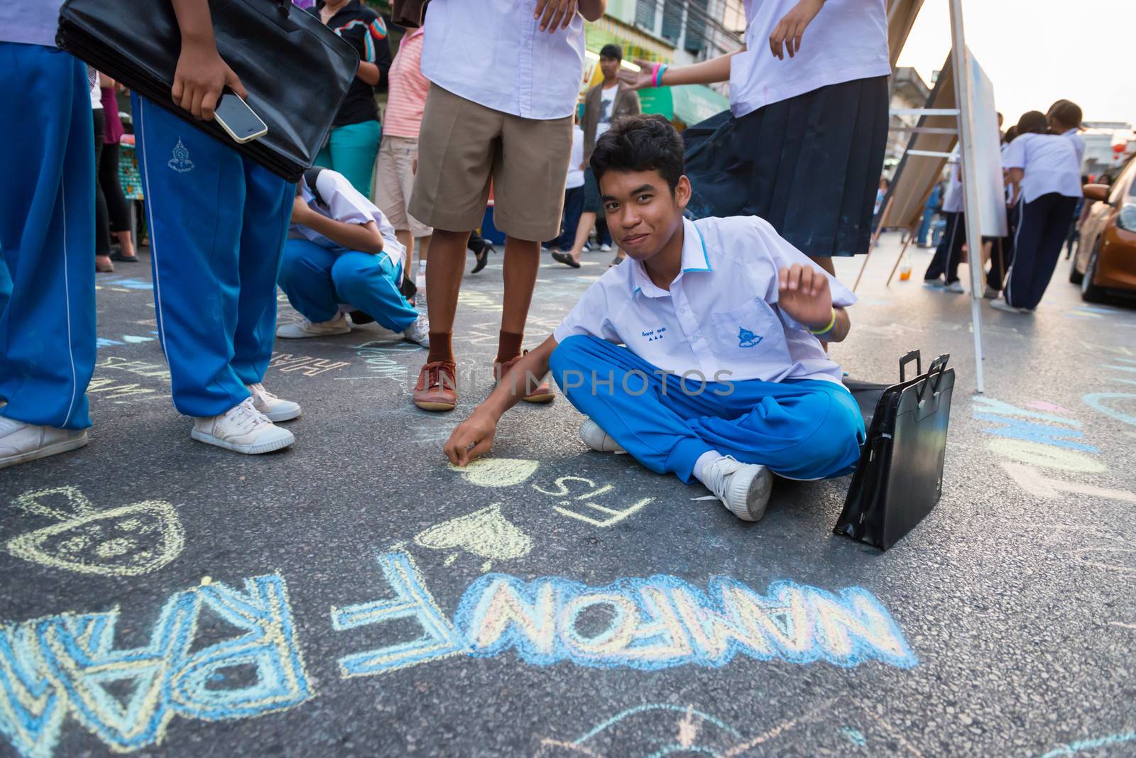 PHUKET, THAILAND - 07 FEB 2014: Unidentified kids draw by chalk on the central street during annual old Phuket town festival. 