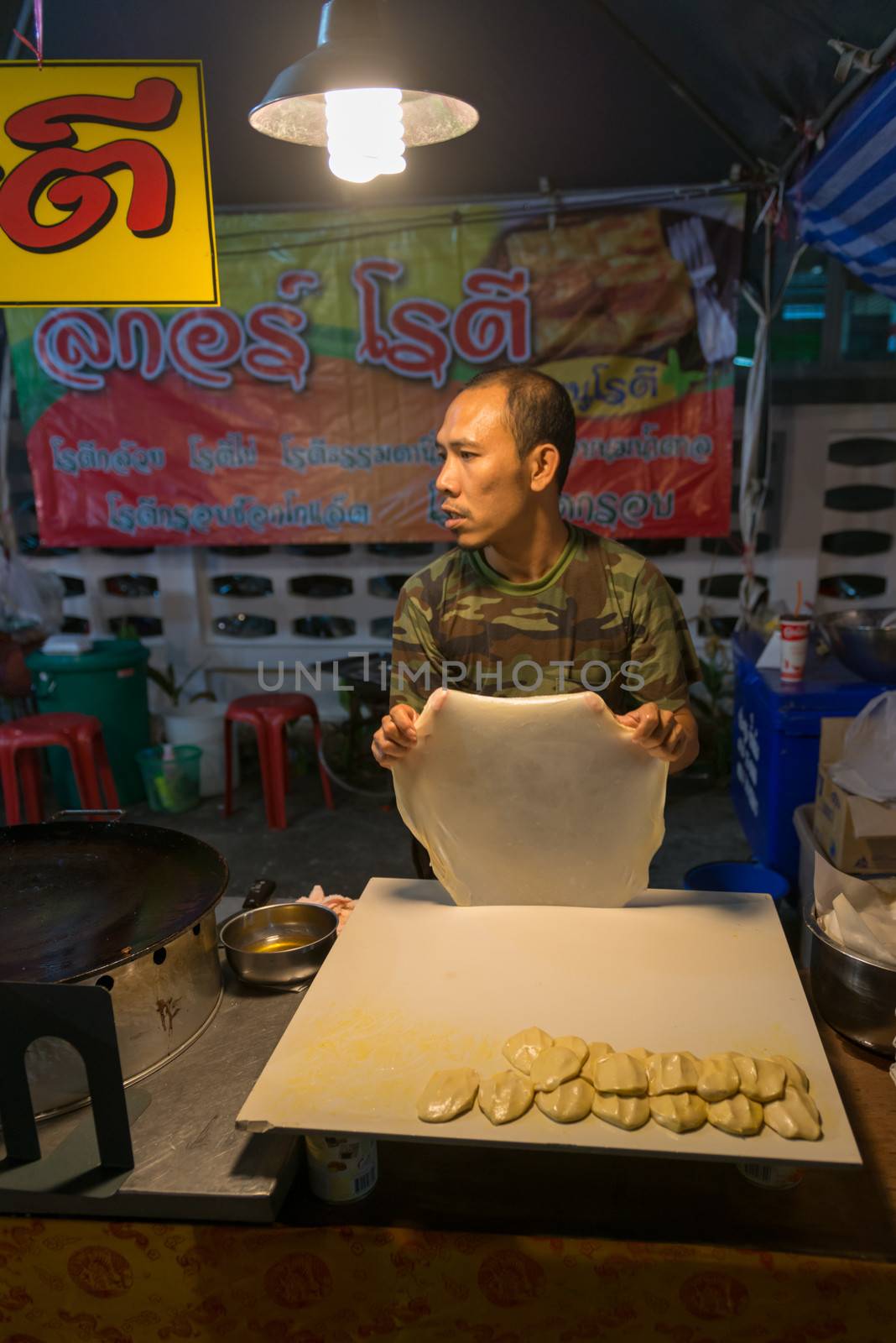 PHUKET, THAILAND - 07 FEB 2014: Unidentified man cook food on street during annual old Phuket town festival. 