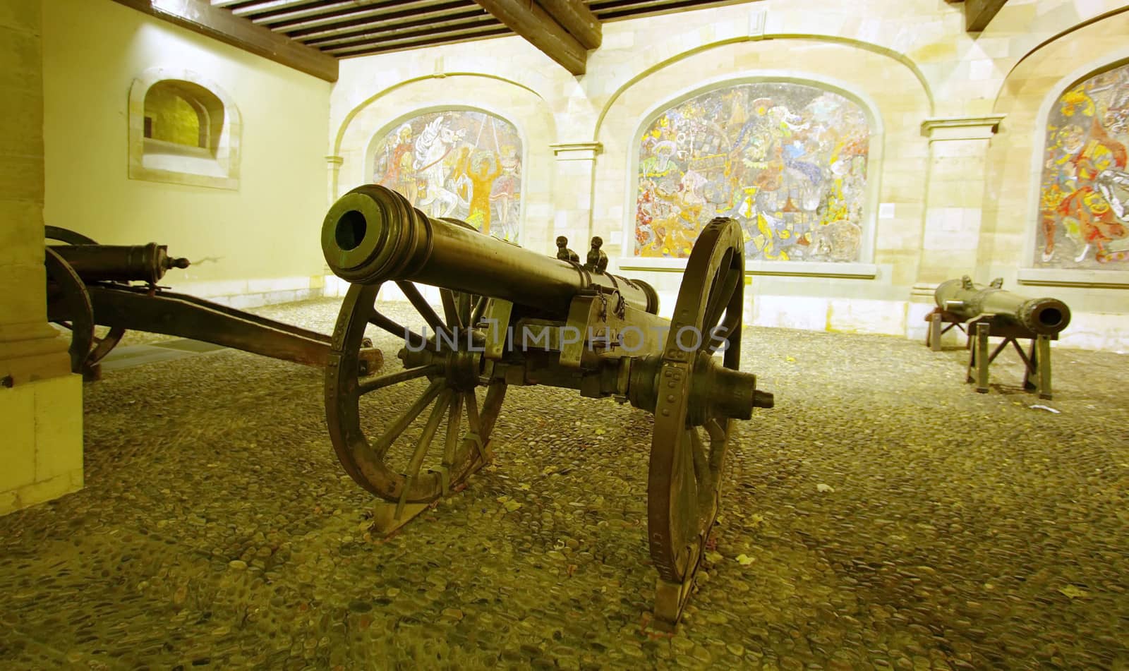 Canons that protects the old city in front of Cingria mosaics at Arsenal courtyard, Geneva, Switzerland