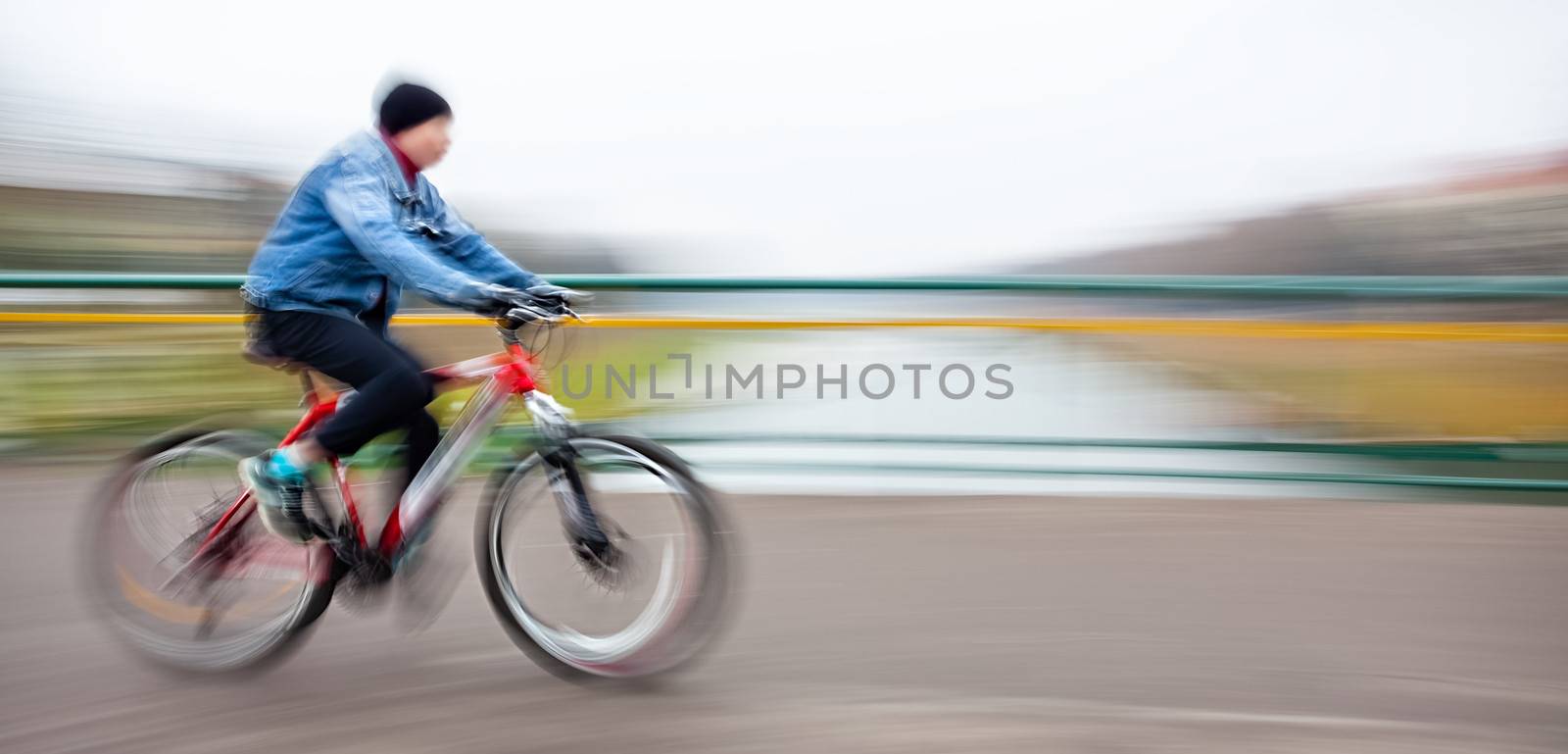 Abstract image of cyclist on the city roadway. Intentional motion blur