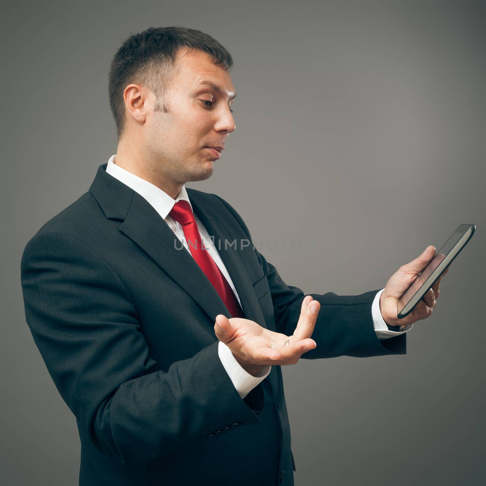 An image of a handsome business man with a tablet pc