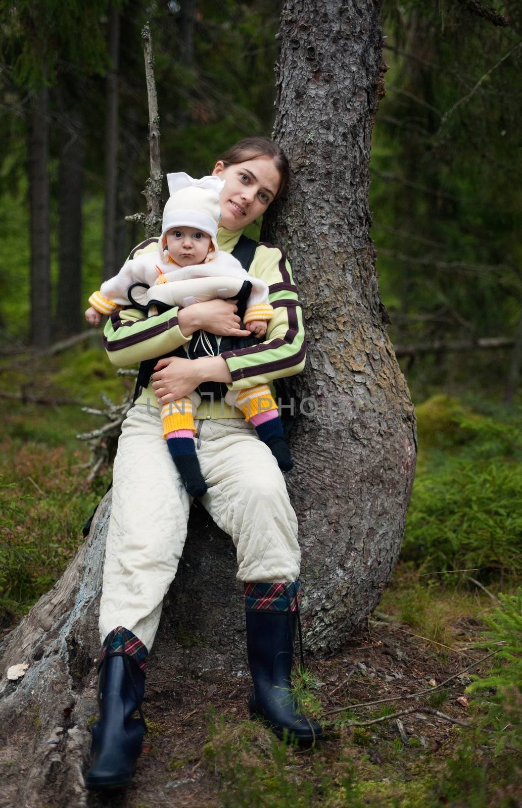 Portrait of Mother and Baby in the wild forest. Beautiful mother and little daughter walking together in summer forest