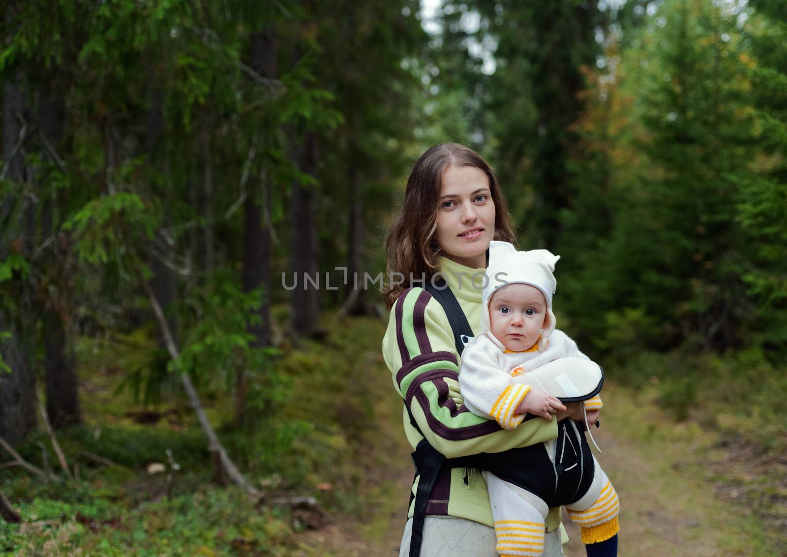 Portrait of Mother and Baby in the wild forest. Beautiful mother and little daughter walking together in summer forest