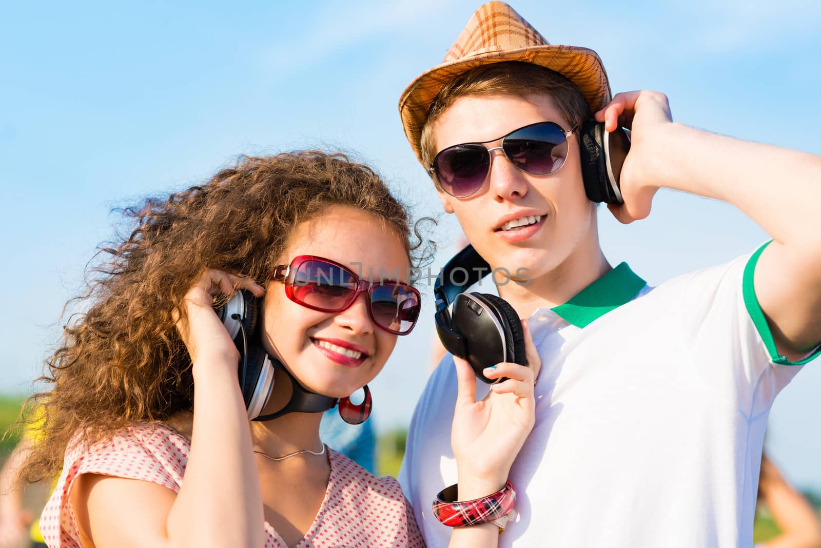 young couple standing on the road, having fun with friends