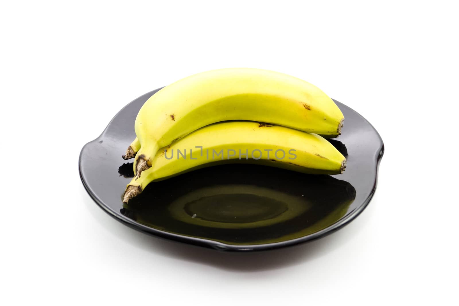 Fresh Yellow Banana on Black Ceramic Plate
