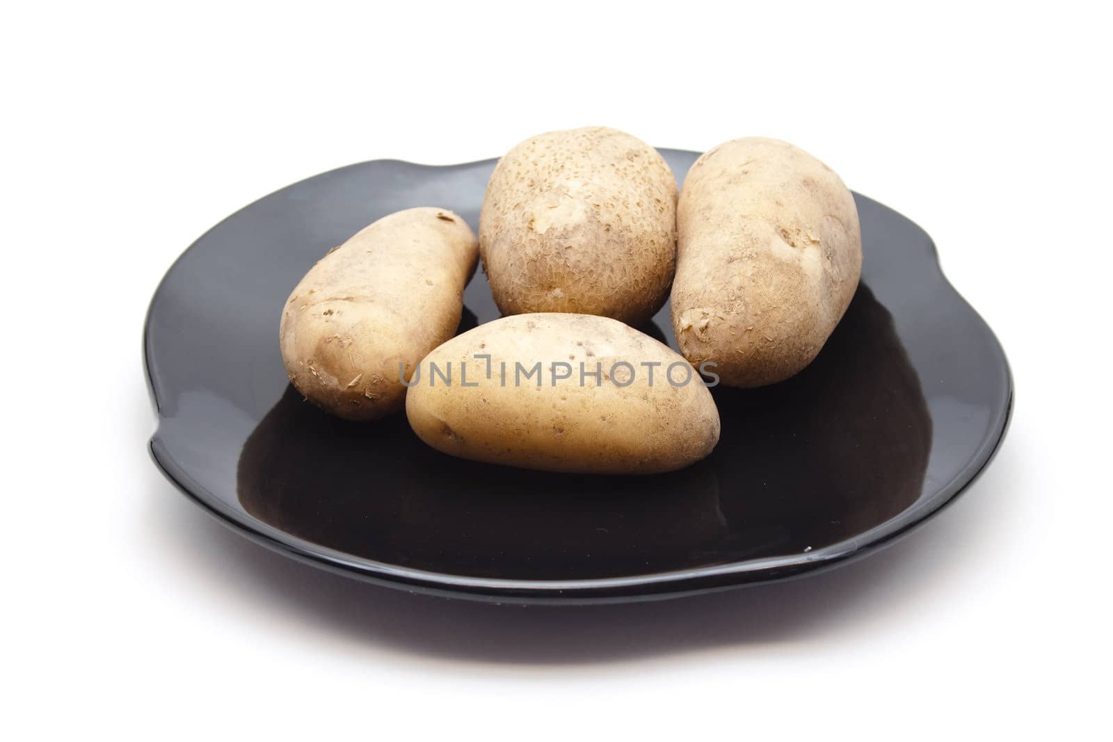 Fresh Brown Potatoes on Ceramic Plate
