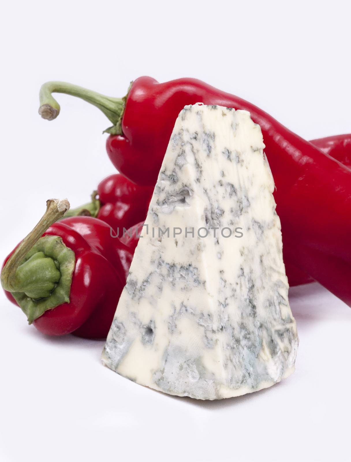 Mold cheese and red pepper on the white bacground.