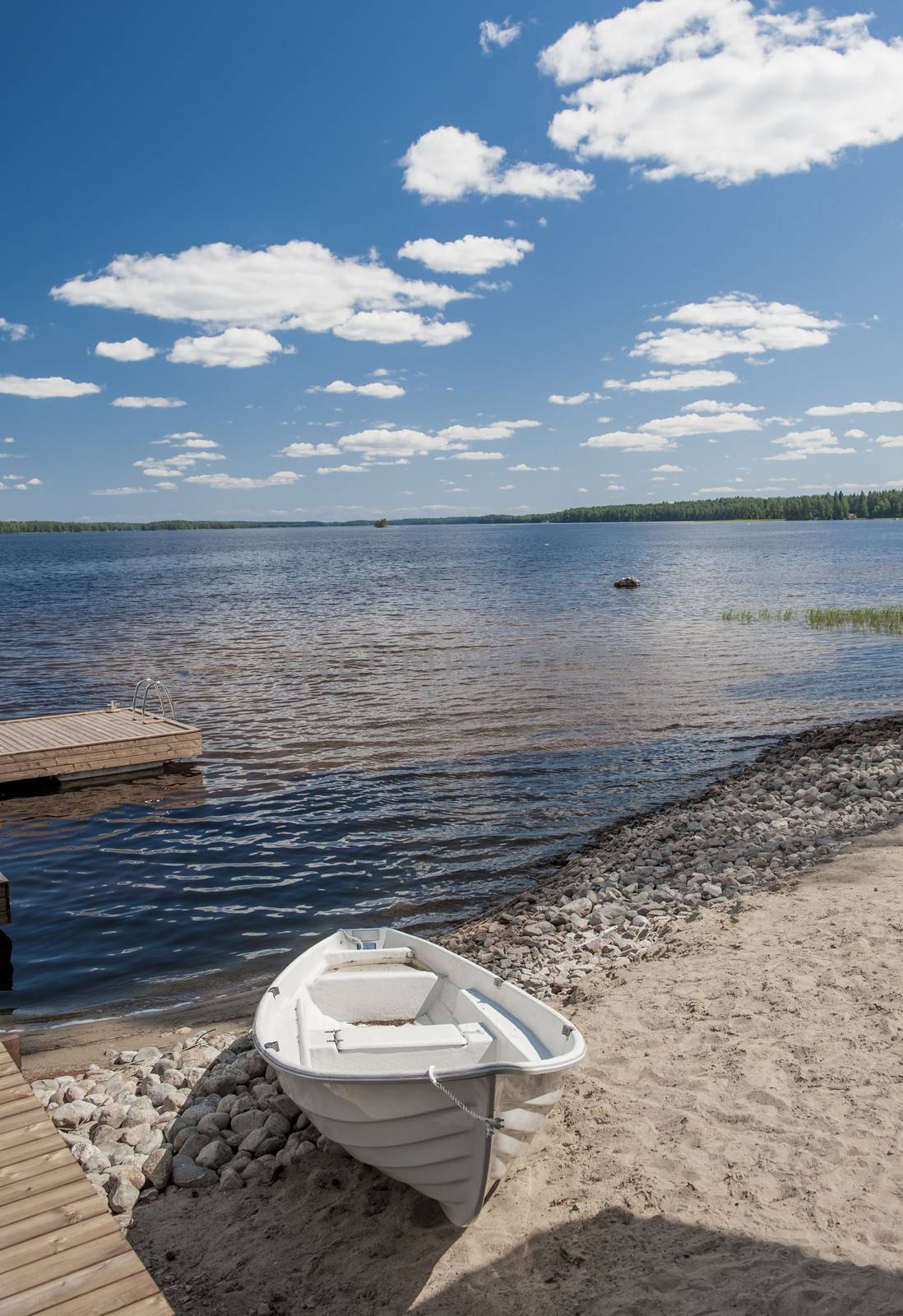 Wooden white boan on the lake in Finlandwhite, white boat,