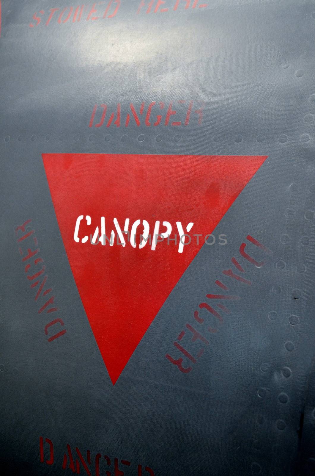 Warning marking on a military aircraft informing of cockpit canopy and procedures that need to be taken.