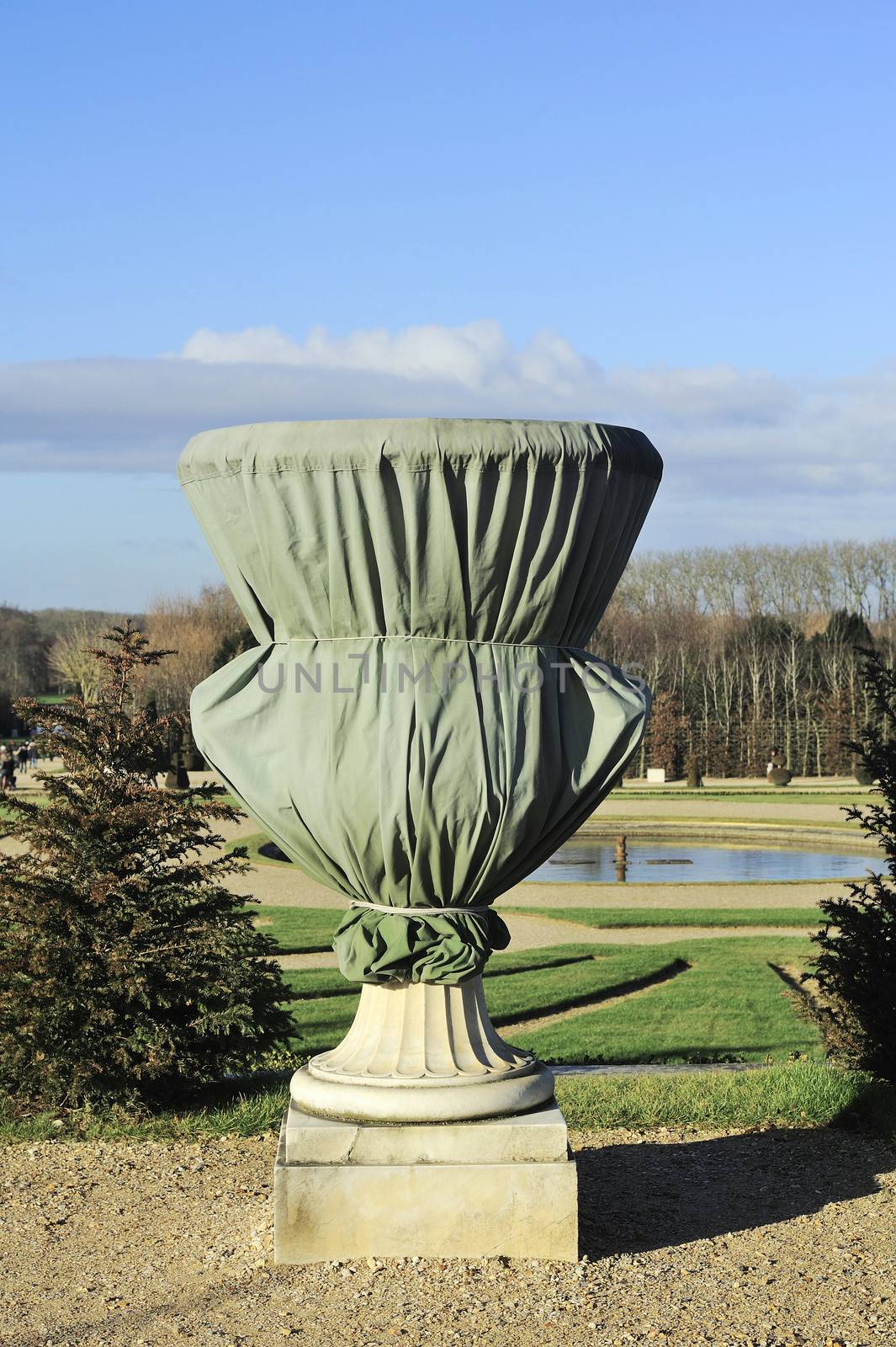 vases and statues in the park of the Chateau of Versailles are protected from freezing in winter