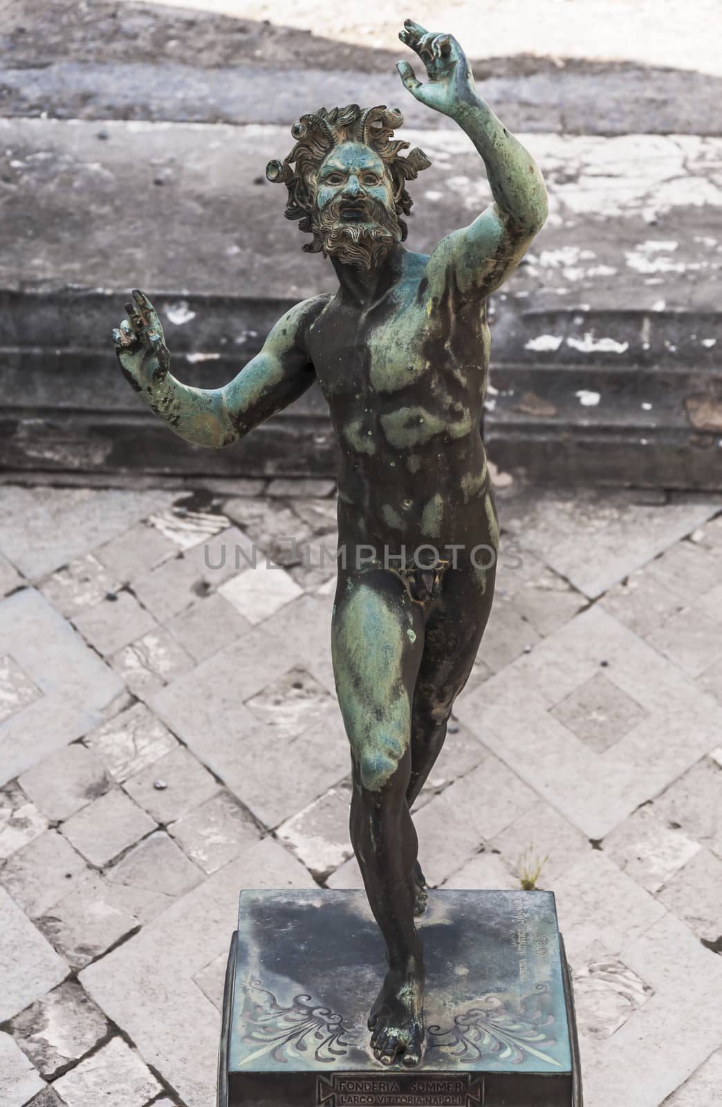 the Fauno bronze statue inside the pompeii ruins, italy