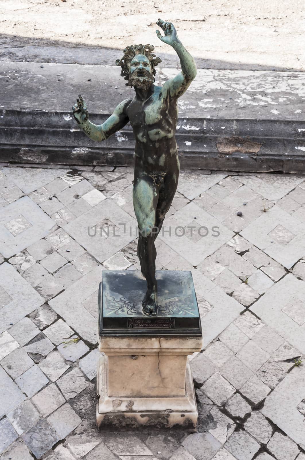 the Fauno bronze statue inside the pompeii ruins, italy