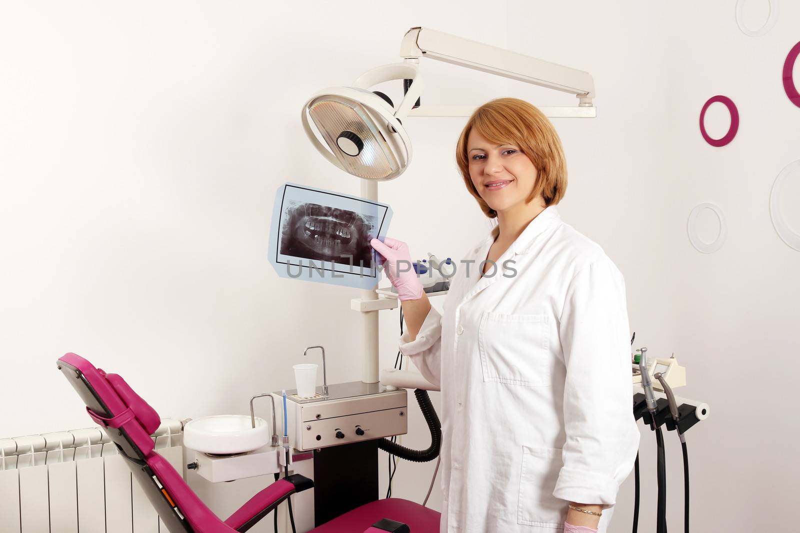 female dentist with x-ray of teeth