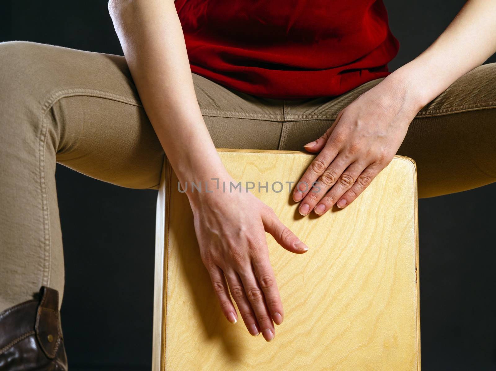 Closeup of a woman playing the Cajon by sumners