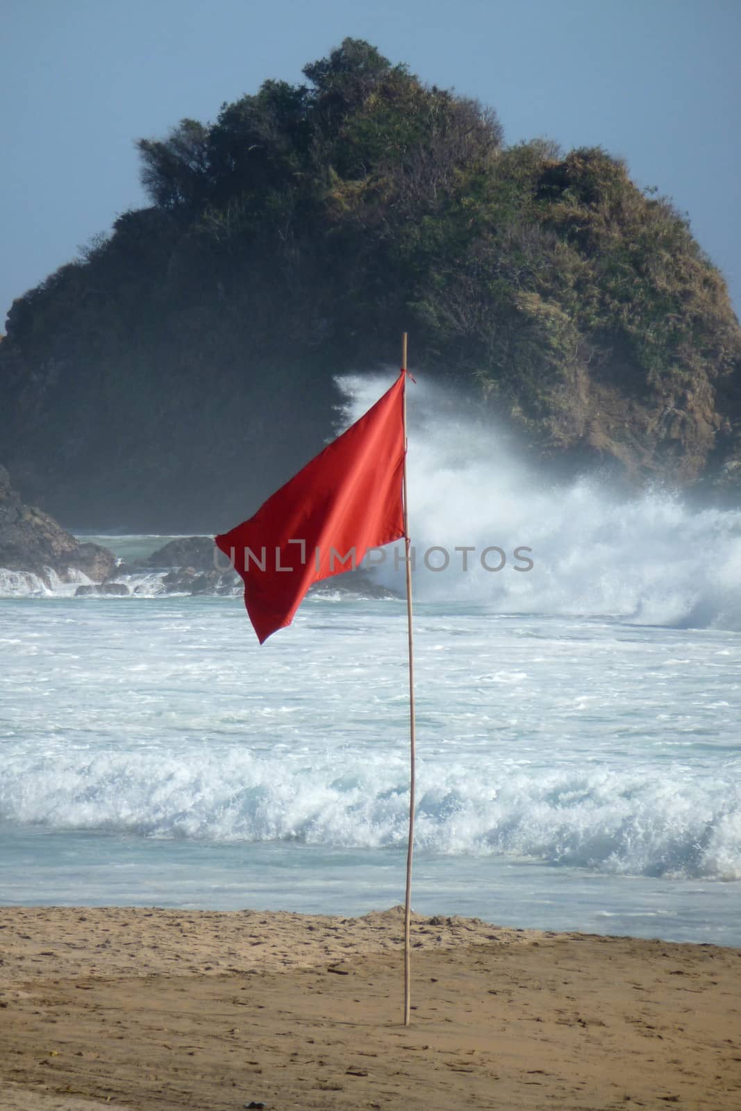 Red flag because of the high waves on the beach at Zipolite, Mexico