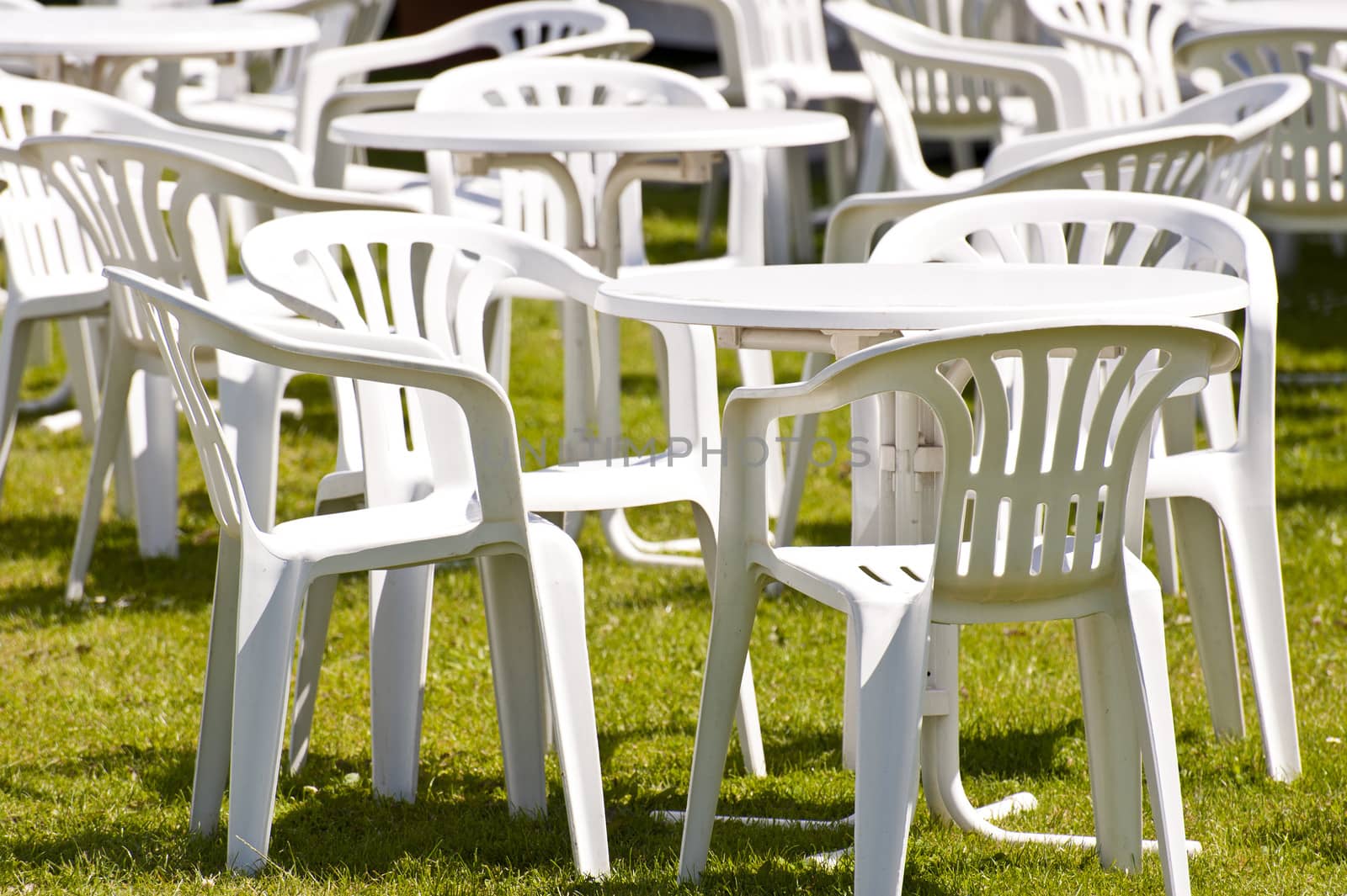 White Plastic Garden Chairs on Grass