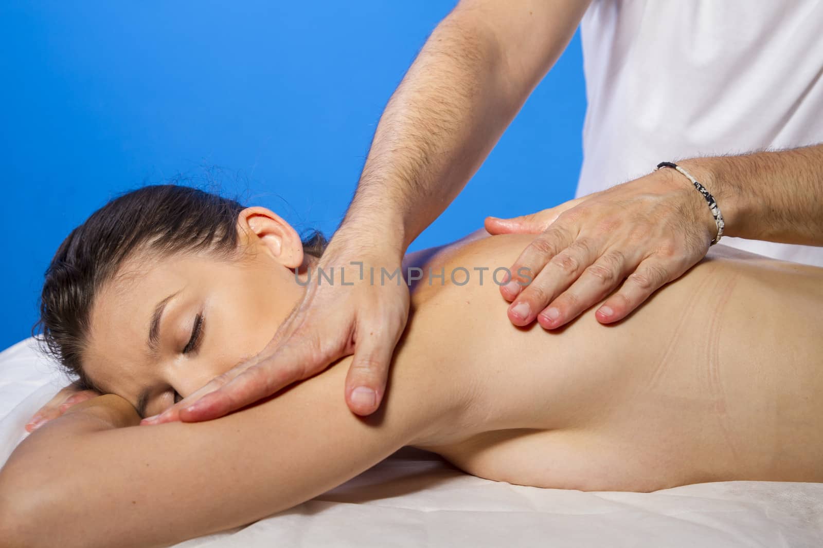 Wellness. Masseur doing massage on woman body in the spa salon. Beauty treatment concept.