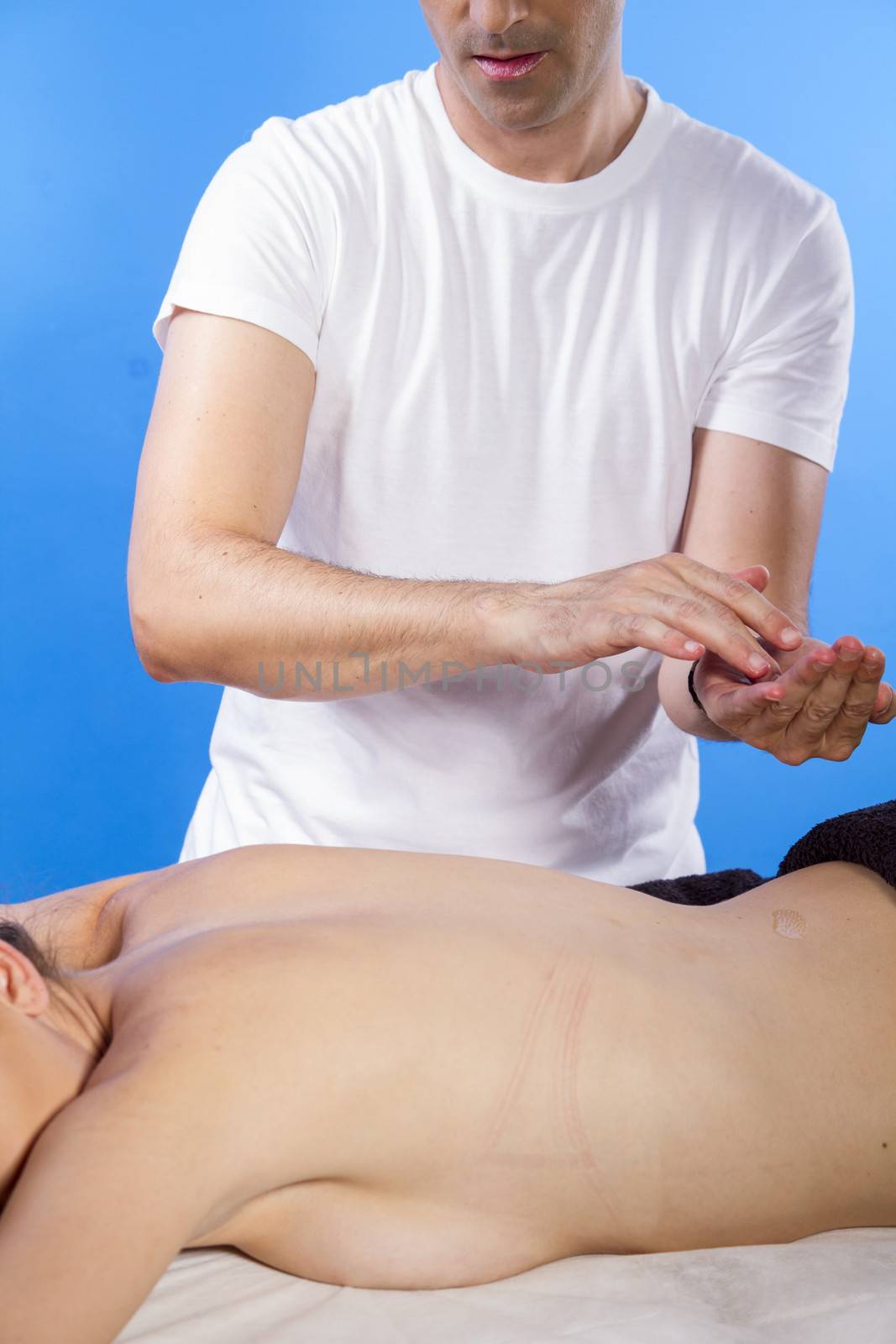 Skin care.Masseur doing massage on woman body in the spa salon. Beauty treatment concept.