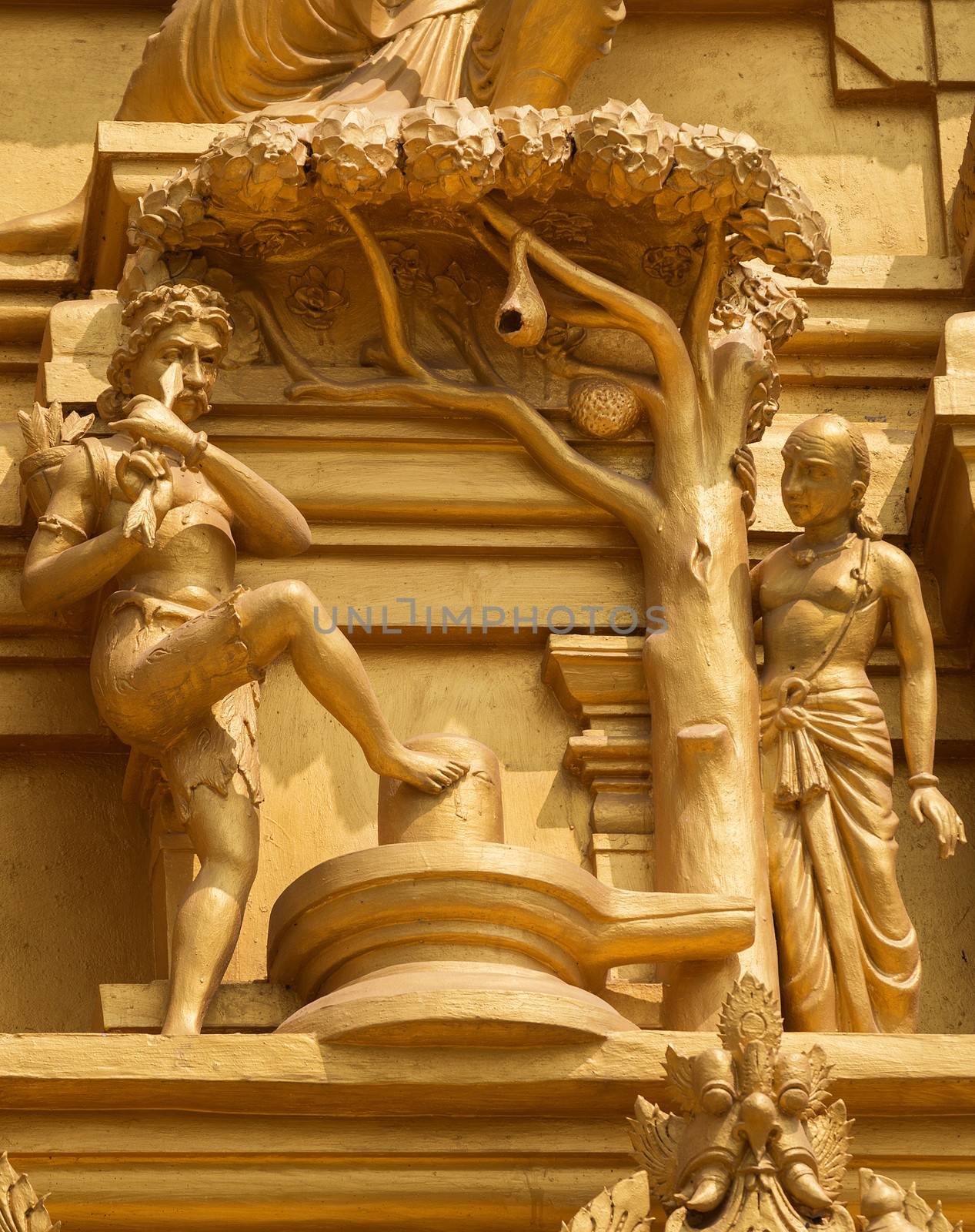 Statue on the golden temple tower of Sri Naheshwara in Bengaluru depicts Kannappa Nayanar, the hunter that donates his eyes to honor Lord Shiva.