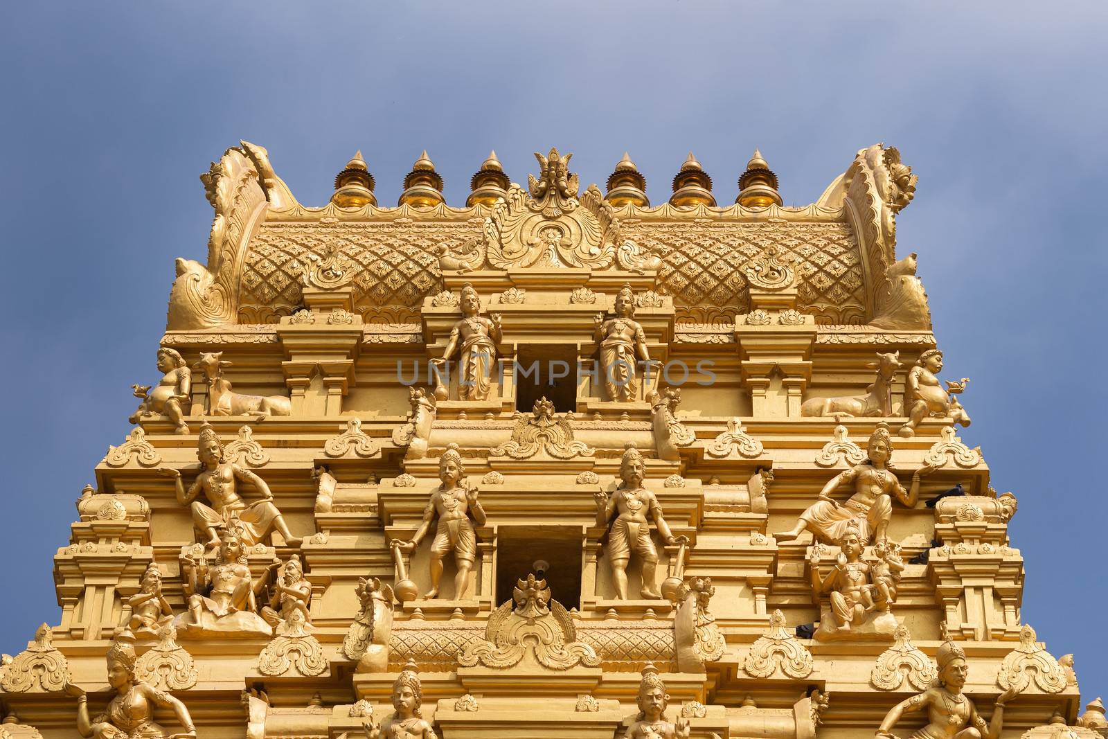 Plenty of golden statues on the top of the entrance tower at Sri Naheshwara in Bengaluru.