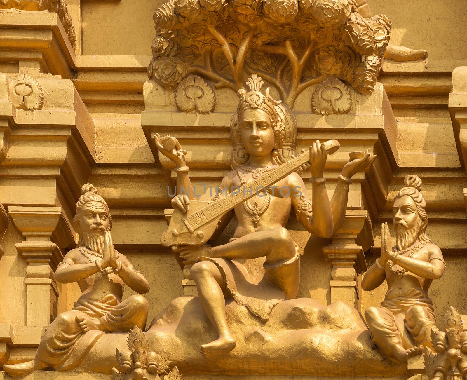 Detail of statues on the golden entrance tower at Sri Naheshwara in Bengaluru: Saraswati, goddess of knowledge and education.