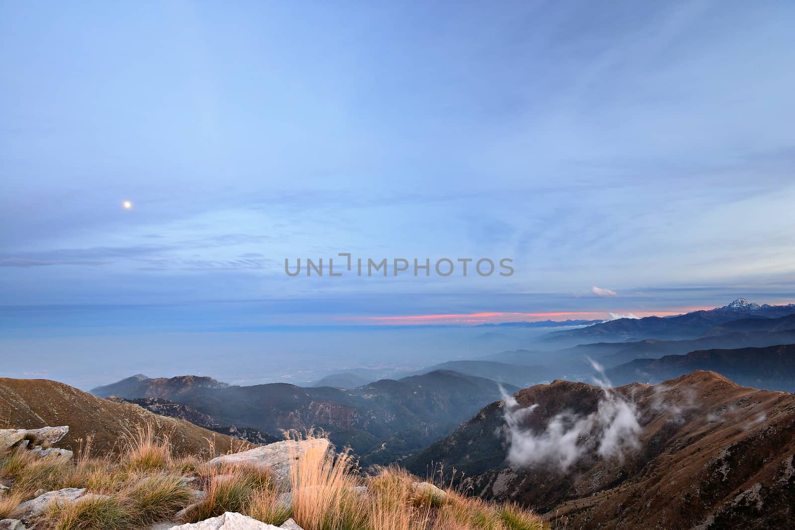 Stunning landscape and romantic cloudscape at sunset in the italian Alps