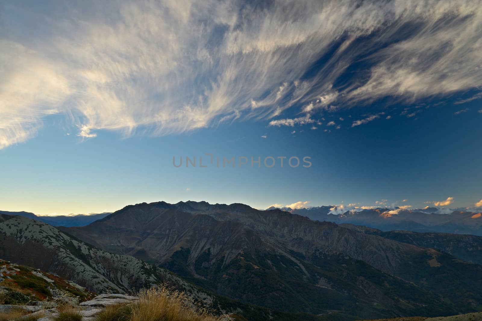 Stunning landscape and romantic cloudscape at sunset in the italian Alps