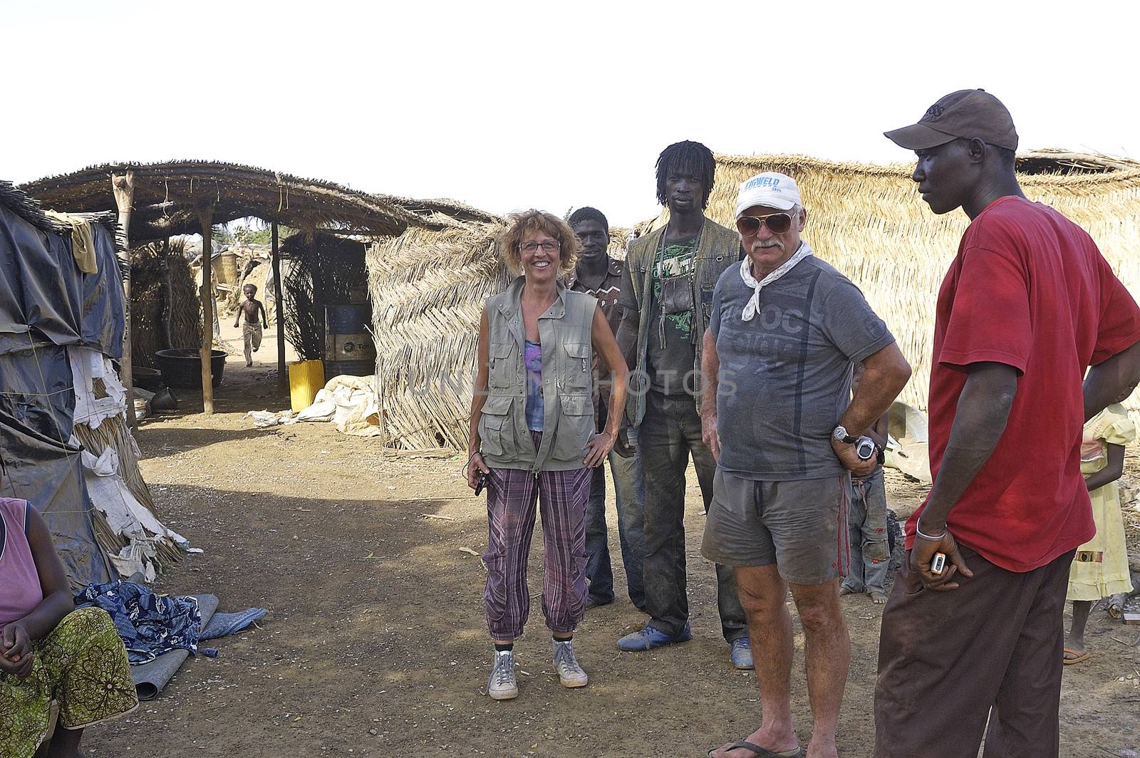 of French gold prospectors came to visit a gold mine of wild Burkina Faso under the suspicious gaze of minors