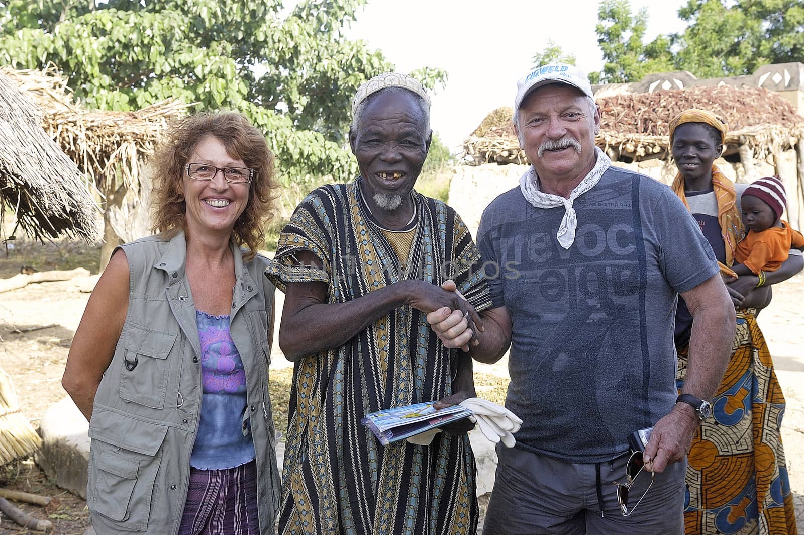 two French tourists makes a visit to a village in Burkina Faso