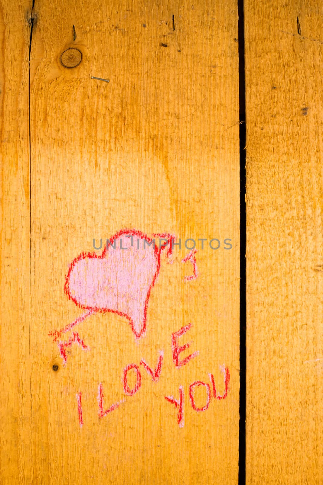 Valentines graffiti on the planks of an old wooden door