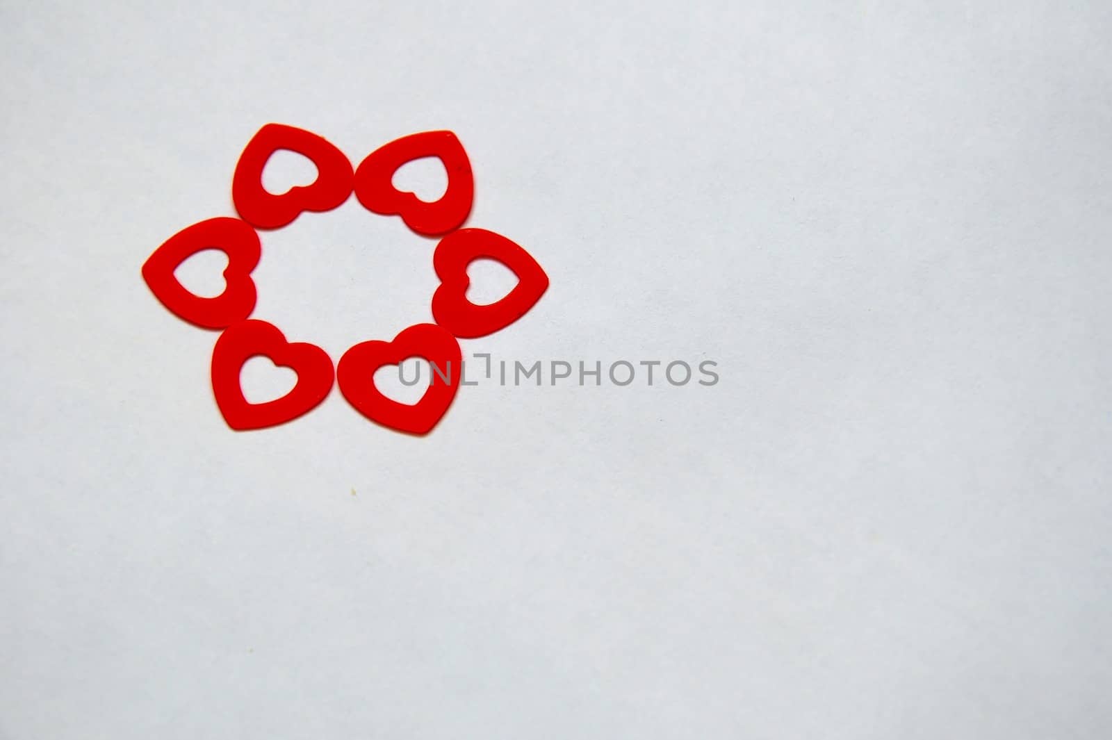 Circle created with red heart shaped confetti