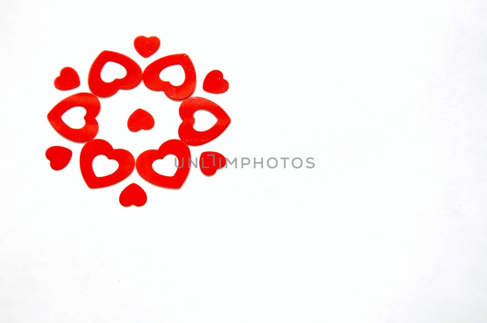 flower created with red heart shaped confetti